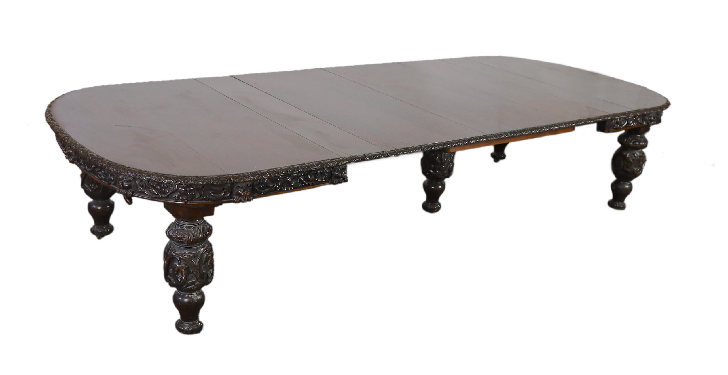 A late Victorian carved oak extending dining table, 178 x 142cm, extends to 356cm H.75cm